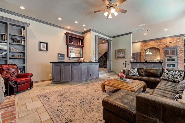 living room featuring ceiling fan, built in features, and ornamental molding