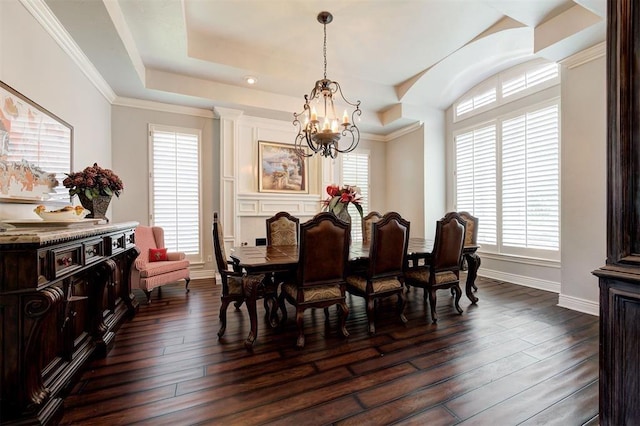 dining area featuring ornamental molding, dark wood-type flooring, an inviting chandelier, and a healthy amount of sunlight