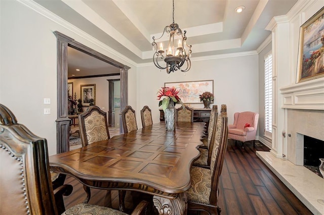 dining space featuring a wealth of natural light, crown molding, a premium fireplace, and dark hardwood / wood-style floors