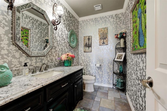 bathroom with crown molding, vanity, and toilet