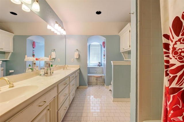 bathroom featuring a shower with curtain, vanity, and tile patterned floors