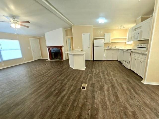 kitchen featuring ceiling fan, white cabinetry, dark hardwood / wood-style flooring, and white appliances