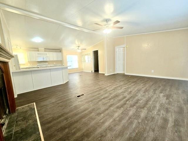 unfurnished living room with ceiling fan, dark hardwood / wood-style flooring, and vaulted ceiling