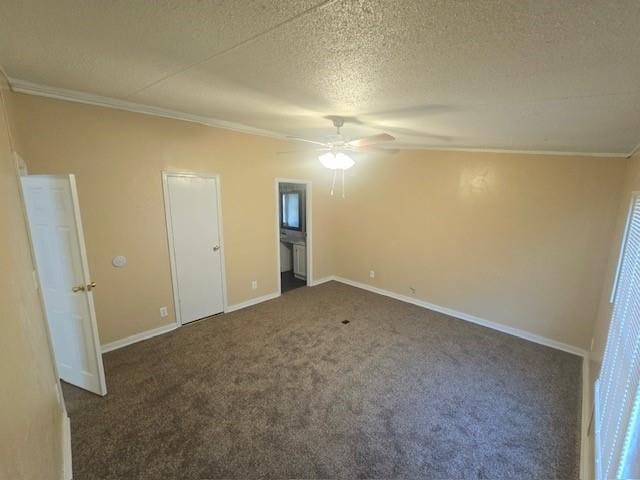 unfurnished bedroom with ceiling fan, ornamental molding, a textured ceiling, and dark colored carpet