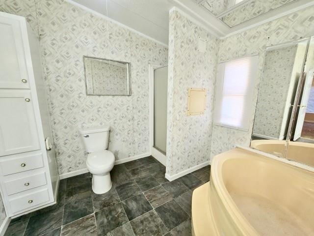 bathroom with toilet, plus walk in shower, and ornamental molding