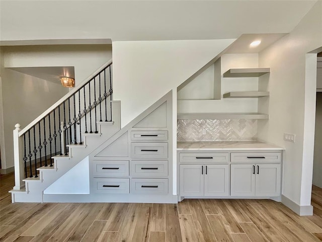 stairs with hardwood / wood-style flooring