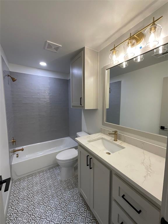 full bathroom featuring tiled shower / bath combo, toilet, and vanity