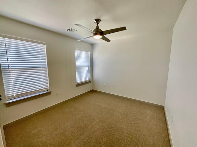 spare room featuring carpet flooring and ceiling fan