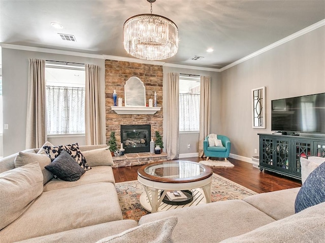 living room featuring a fireplace, crown molding, dark hardwood / wood-style flooring, and a chandelier