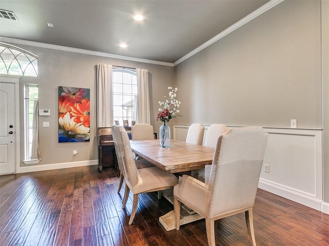 dining space featuring crown molding and dark wood-type flooring