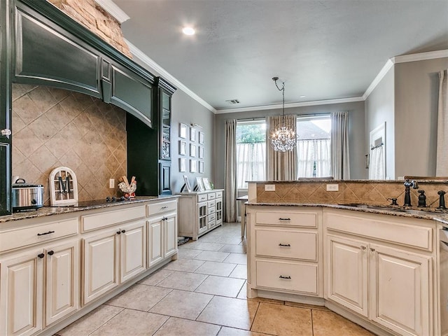 kitchen with decorative backsplash, sink, ornamental molding, and hanging light fixtures