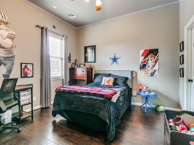 bedroom with dark hardwood / wood-style floors