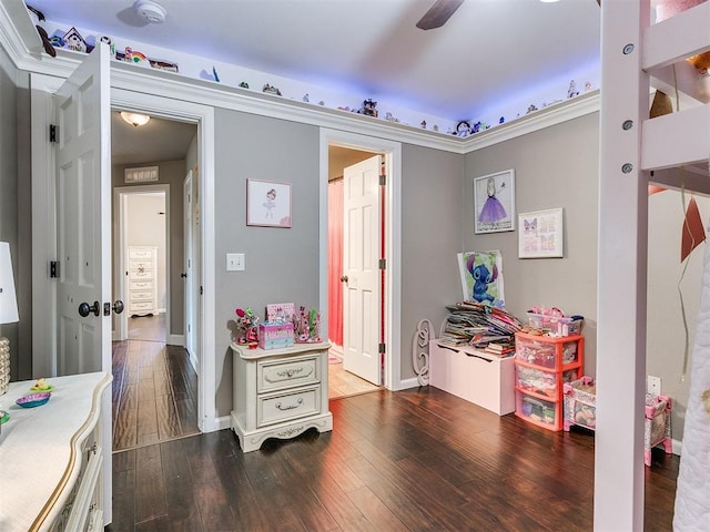 rec room with ceiling fan and dark wood-type flooring