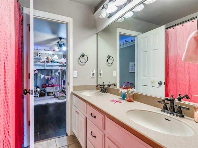 bathroom with hardwood / wood-style flooring, ceiling fan, and vanity