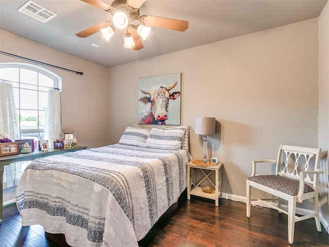 bedroom with dark hardwood / wood-style floors and ceiling fan