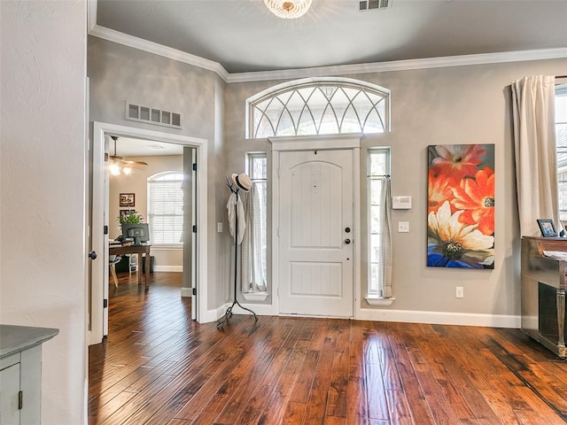 foyer with dark hardwood / wood-style floors, ceiling fan, and crown molding