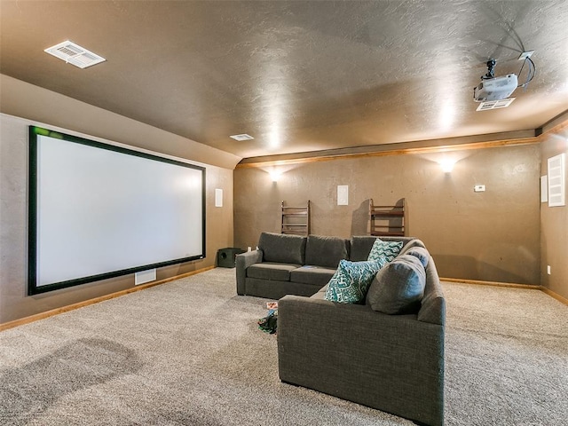 cinema room featuring carpet and a textured ceiling