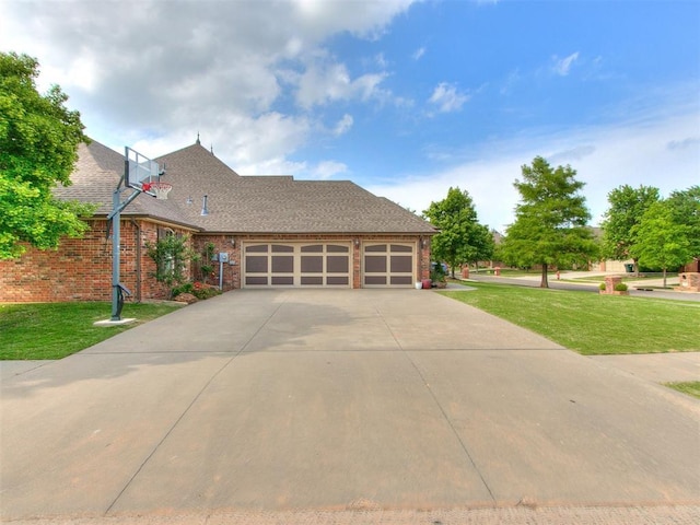 view of front of house featuring a garage and a front lawn