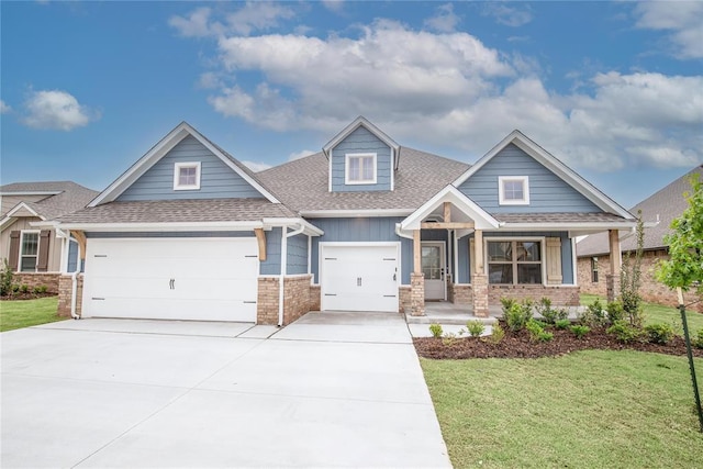 9317 Cheek Ranch Rd, Yukon, OK 73099 - craftsman-style house featuring a shingled roof, a garage, a front yard, covered porch, and driveway