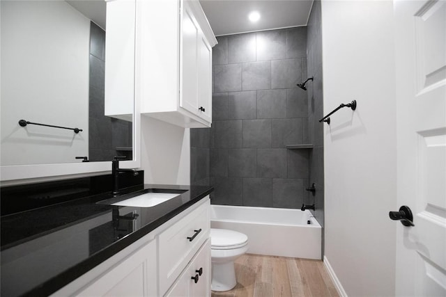 9317 Cheek Ranch Rd, Yukon, OK 73099 - bathroom featuring wood finished floors, vanity, baseboards, toilet, and tub / shower combination