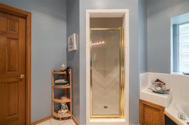 bathroom featuring tile patterned floors and separate shower and tub