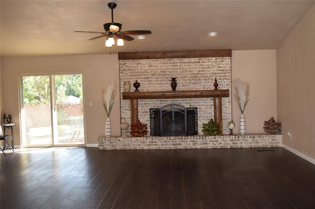 unfurnished living room featuring ceiling fan, wood-type flooring, and a fireplace