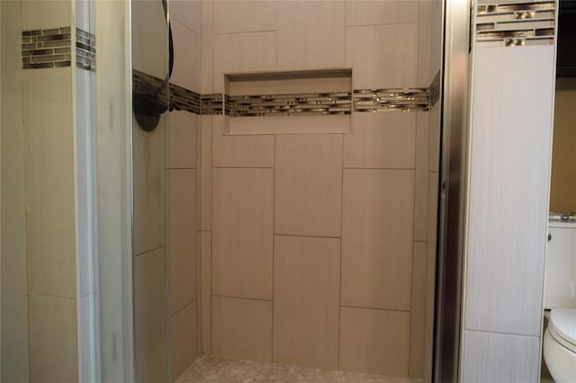 bathroom featuring toilet and walk in shower