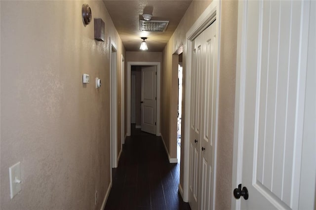 corridor with dark hardwood / wood-style floors