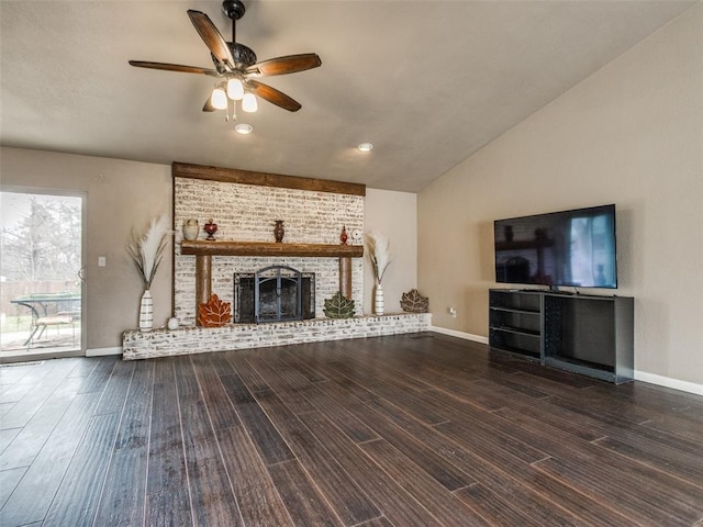 unfurnished living room with baseboards, lofted ceiling, a fireplace, wood finished floors, and a ceiling fan