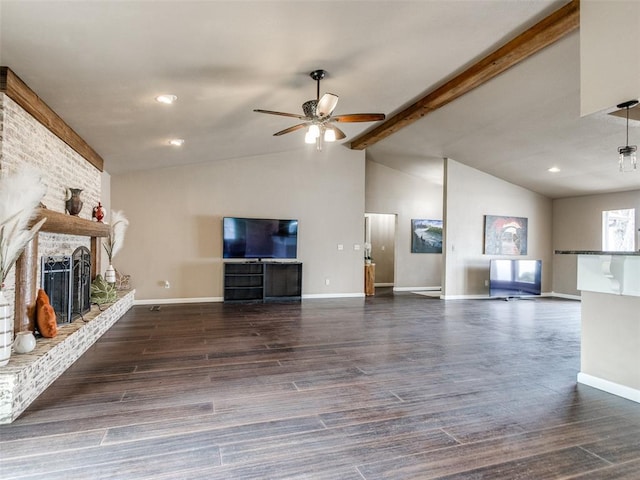 unfurnished living room featuring lofted ceiling with beams, a brick fireplace, wood finished floors, and ceiling fan