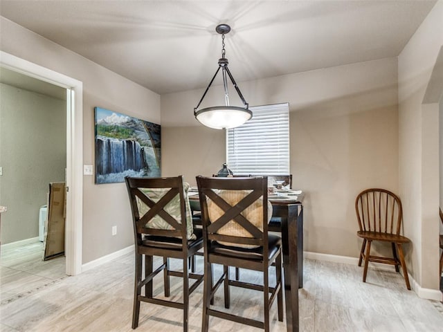 dining area featuring baseboards