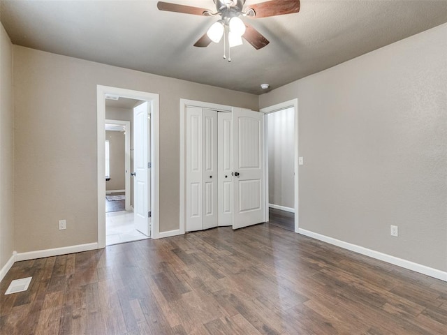 unfurnished bedroom featuring wood finished floors, visible vents, and baseboards