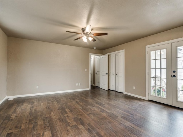 unfurnished bedroom featuring dark wood finished floors, french doors, baseboards, and a ceiling fan