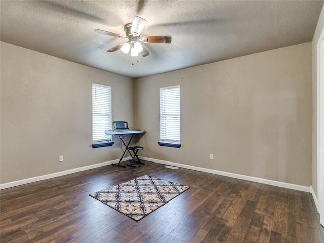 miscellaneous room with a textured ceiling, wood finished floors, baseboards, and ceiling fan