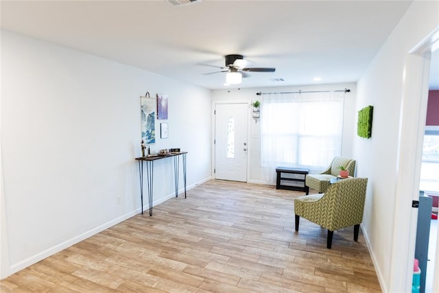 sitting room featuring ceiling fan and light wood-type flooring