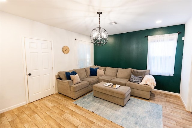 living room featuring hardwood / wood-style flooring and a notable chandelier