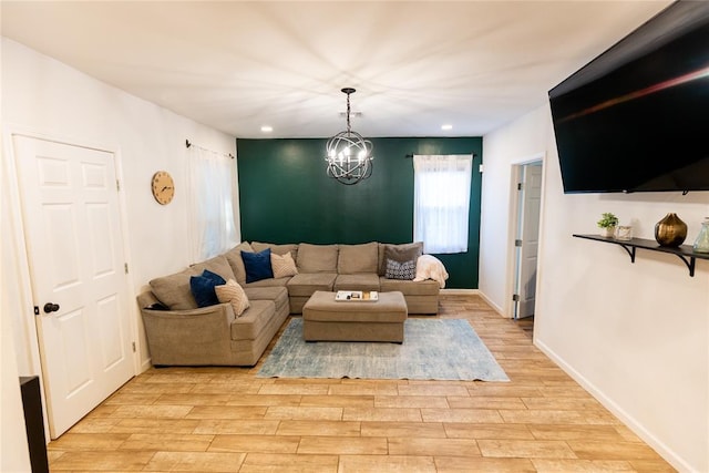 living room featuring light wood-type flooring and an inviting chandelier