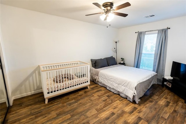 bedroom with ceiling fan and dark hardwood / wood-style flooring