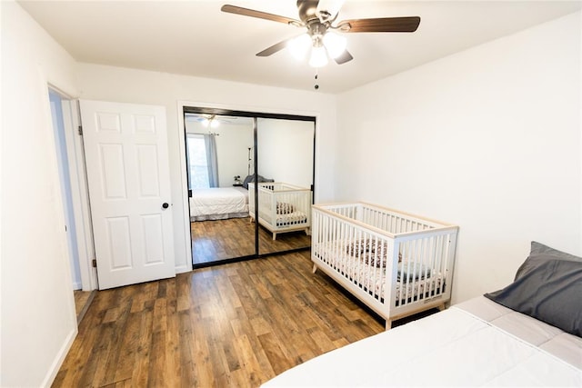 bedroom featuring dark hardwood / wood-style flooring, a closet, and ceiling fan