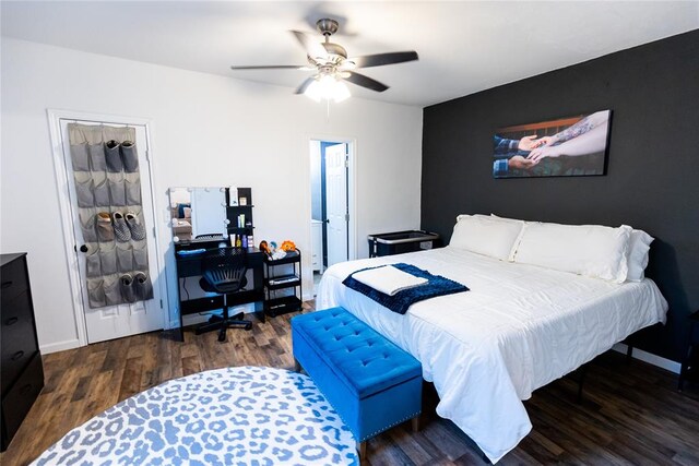 bedroom with ceiling fan and dark wood-type flooring