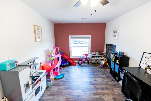 recreation room featuring dark hardwood / wood-style floors and ceiling fan