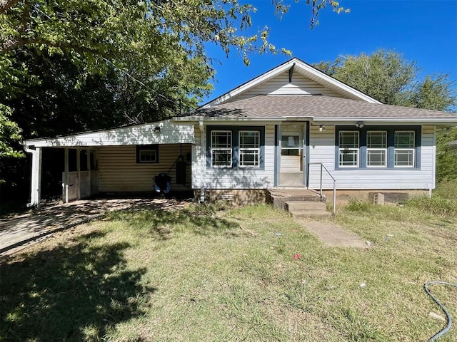 ranch-style house with a front yard, a porch, and a carport