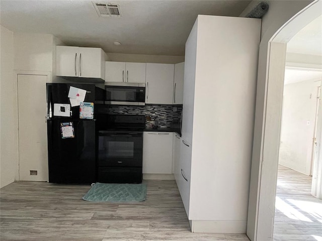 kitchen featuring black appliances, decorative backsplash, white cabinets, and light hardwood / wood-style flooring