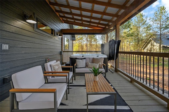 deck with an outdoor living space and a hot tub