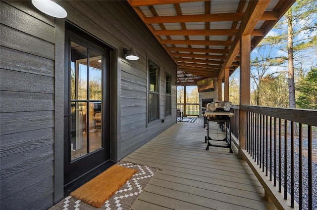 wooden terrace with a grill