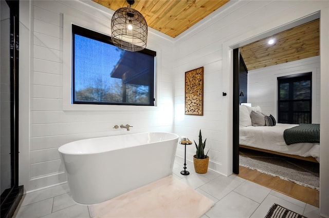 bathroom featuring a tub to relax in, hardwood / wood-style flooring, wooden ceiling, and wood walls