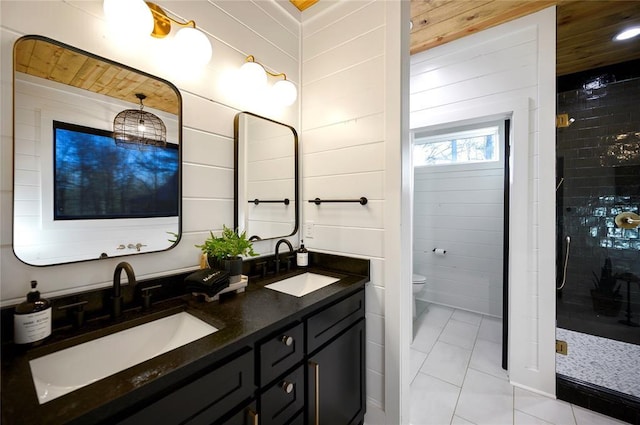 bathroom with tile patterned floors, toilet, wooden walls, vanity, and wood ceiling