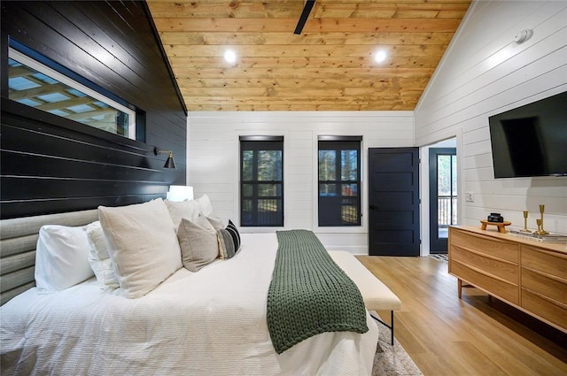 bedroom with wood walls, light wood-type flooring, wooden ceiling, and high vaulted ceiling