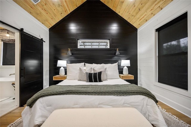 bedroom featuring a barn door, wooden ceiling, and lofted ceiling