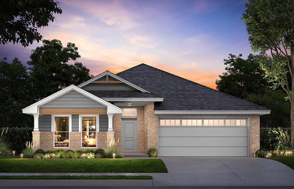 view of front of home with a lawn and a garage